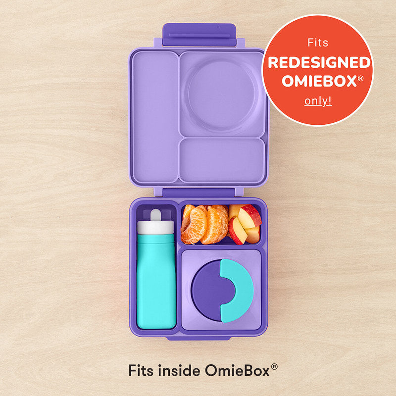 Purple bento box with compartments containing food and a bottle, on a beige background.