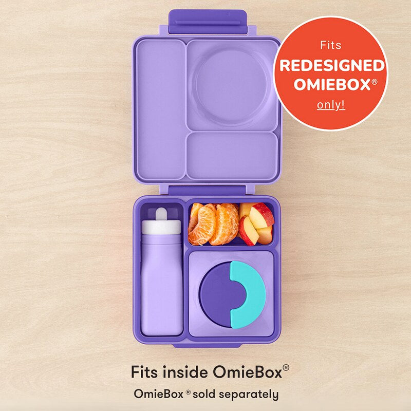 Purple bento box with compartments filled with food and a bottle, on a beige background.