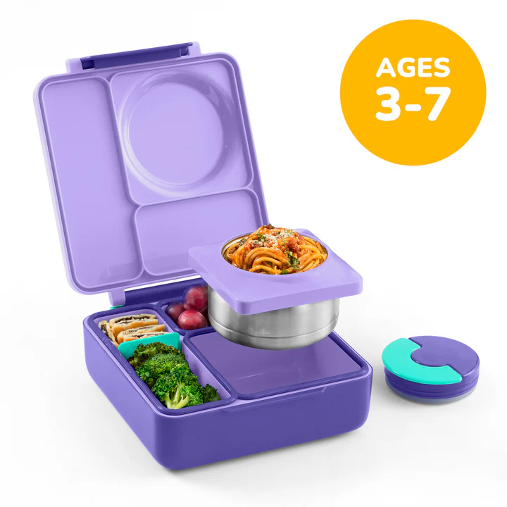Purple children's lunch box with compartments filled with food, on a white background.