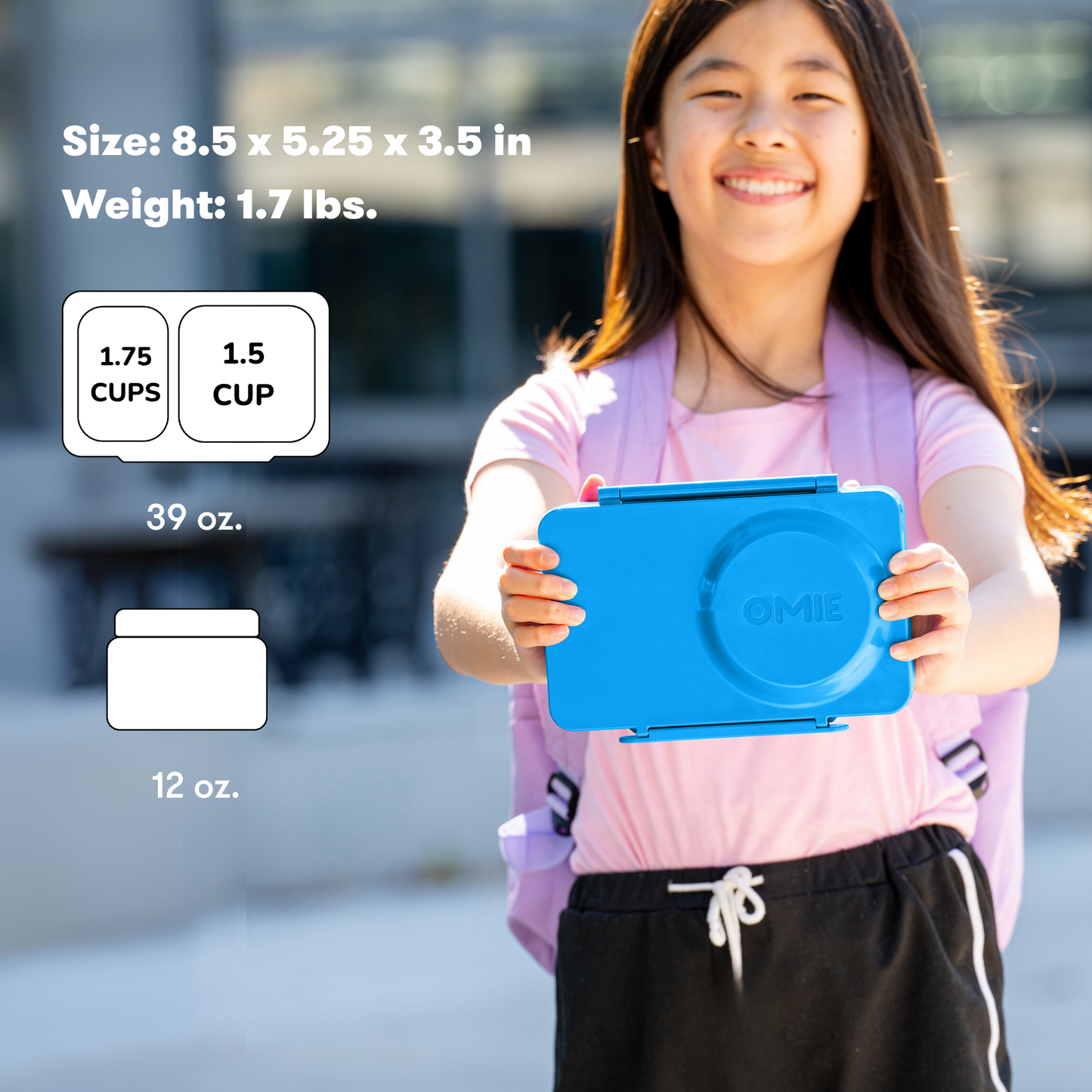 Girl holding a blue container with product details on a blurred outdoor background