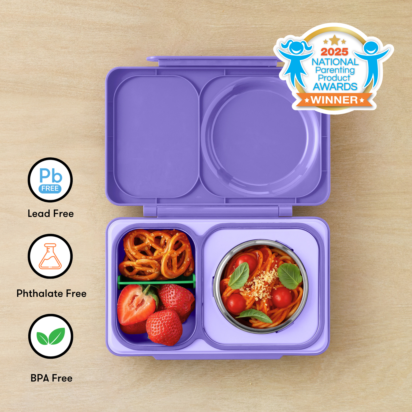 Purple bento box with compartments filled with snacks on a wooden surface, featuring 'Pb Free', 'Phthalate Free', and 'BPA Free' labels, and a 2025 National Parenting Product Awards winner badge.