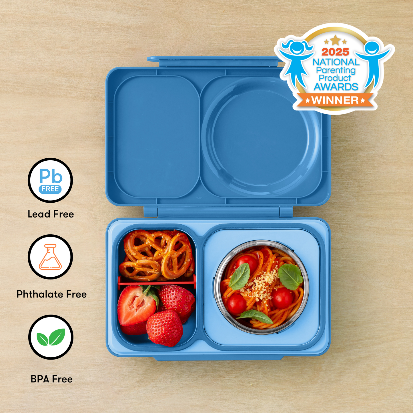 Blue bento box with food compartments on a wooden surface, featuring 'Pb Free', 'Phthalate Free', and 'BPA Free' labels, and a 2025 National Parenting Product Awards winner badge.