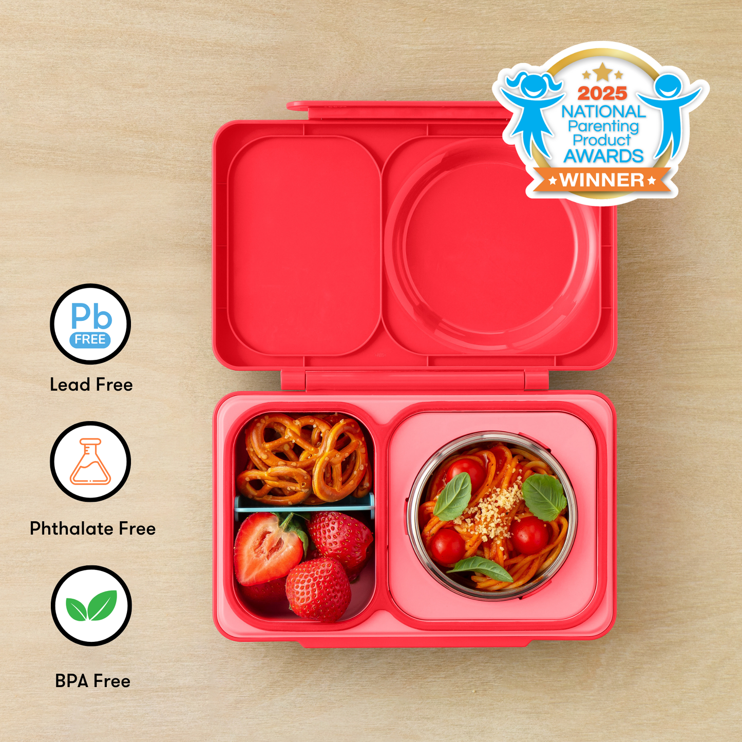 Red bento box with compartments filled with food on a wooden surface, featuring 'Pb Free', 'Phthalate Free', and 'BPA Free' labels, and a 2025 National Parenting Product Award winner badge.