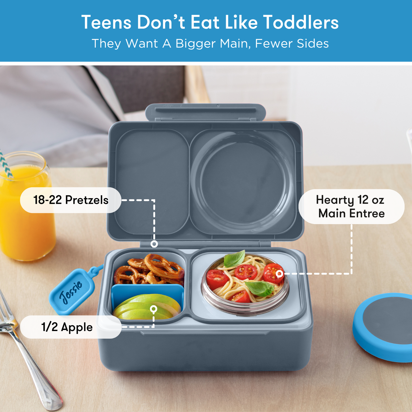 Bento box with compartments labeled for food items on a table.