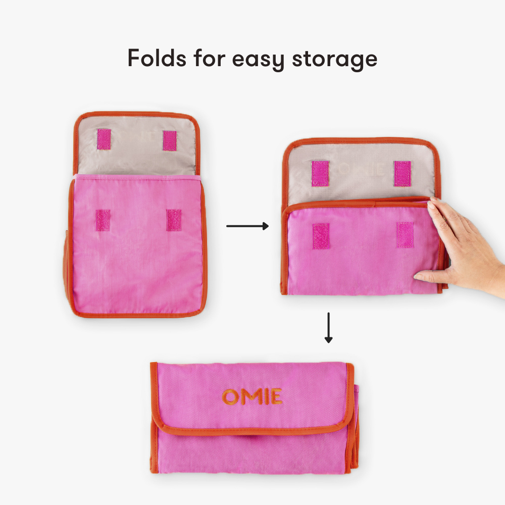 Pink pouch with orange accents being folded for easy storage, labeled 'OMIE'.