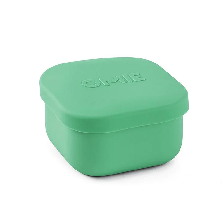 A collection of colorful silicone snack containers in various shades of red, orange, green, blue, and purple, designed to be used with an OmieBox.