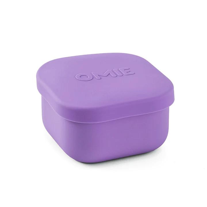 A collection of colorful silicone snack containers in various shades of red, orange, green, blue, and purple, designed to be used with an OmieBox.
