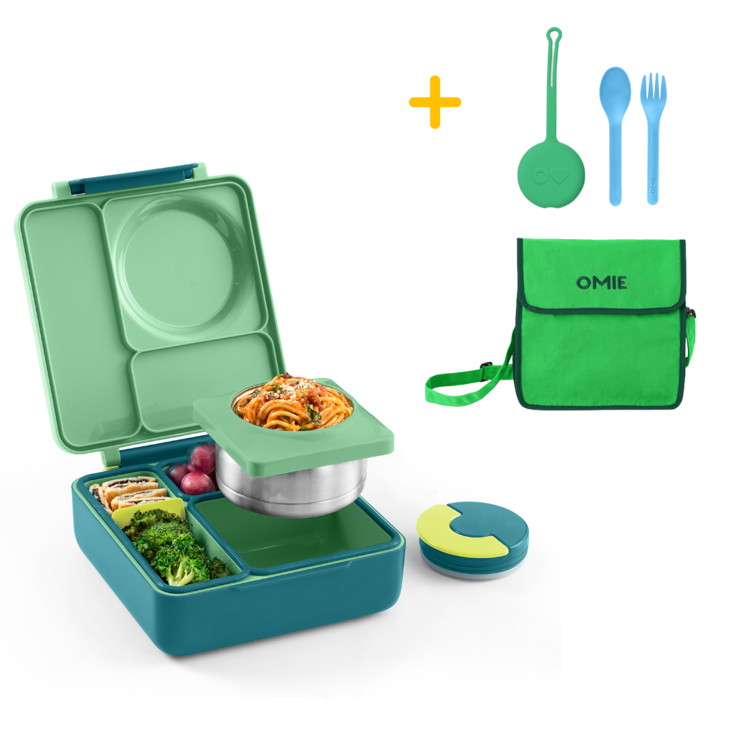 Green bento box with food compartments, a green bag, and utensils on a white background.