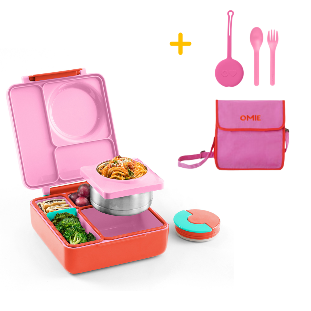 Pink and orange bento box with food compartments, pink bag, utensils, and a container on a white background.