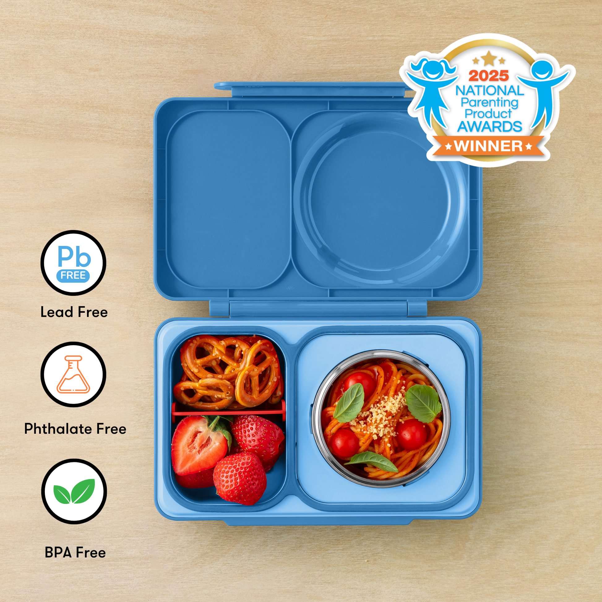 Blue bento box with food compartments on a wooden surface, featuring 'Pb Free', 'Phthalate Free', and 'BPA Free' labels, and a 2025 National Parenting Product Awards winner badge.