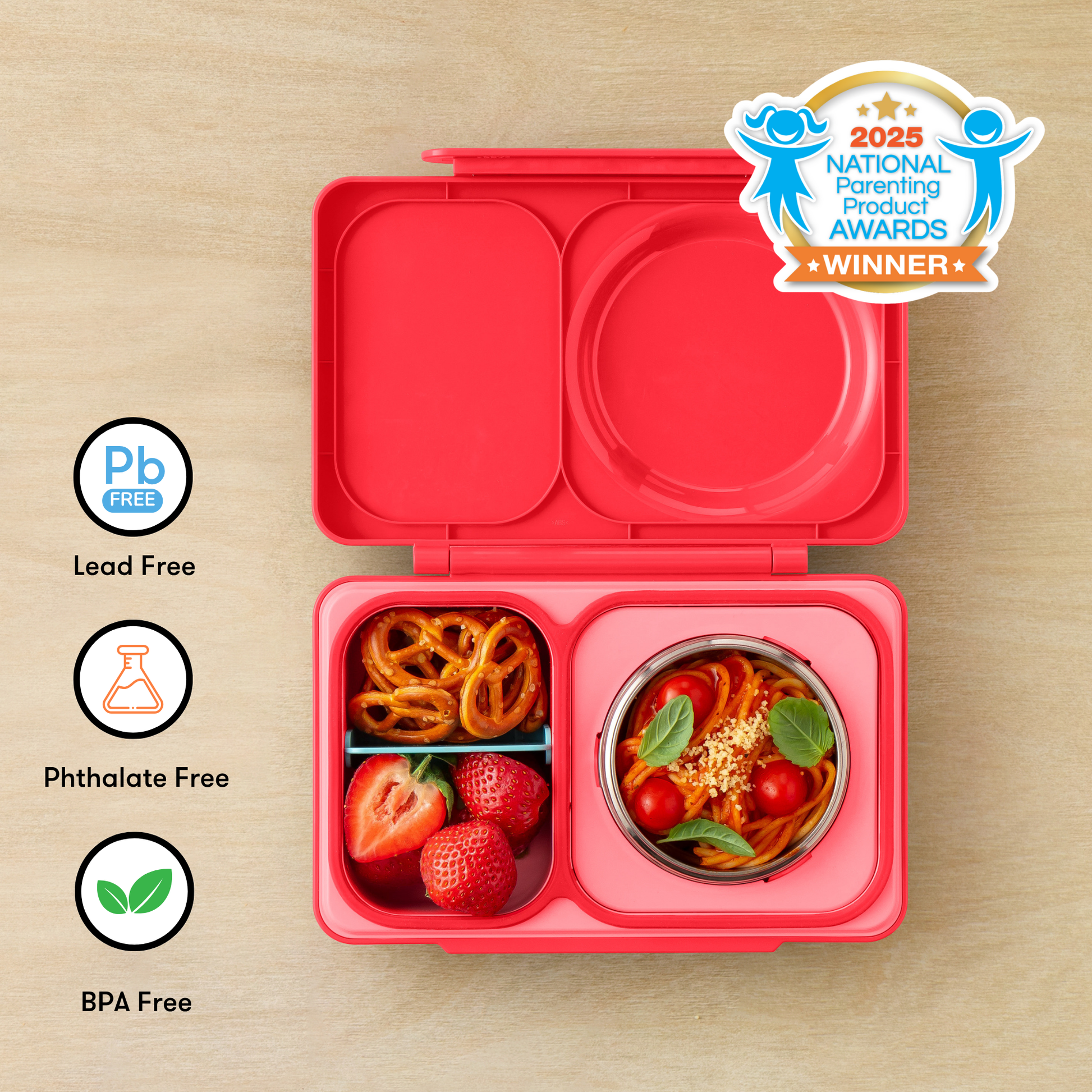 Red bento box with compartments filled with food on a wooden surface, featuring 'Pb Free', 'Phthalate Free', and 'BPA Free' labels, and a 2025 National Parenting Product Award winner badge.