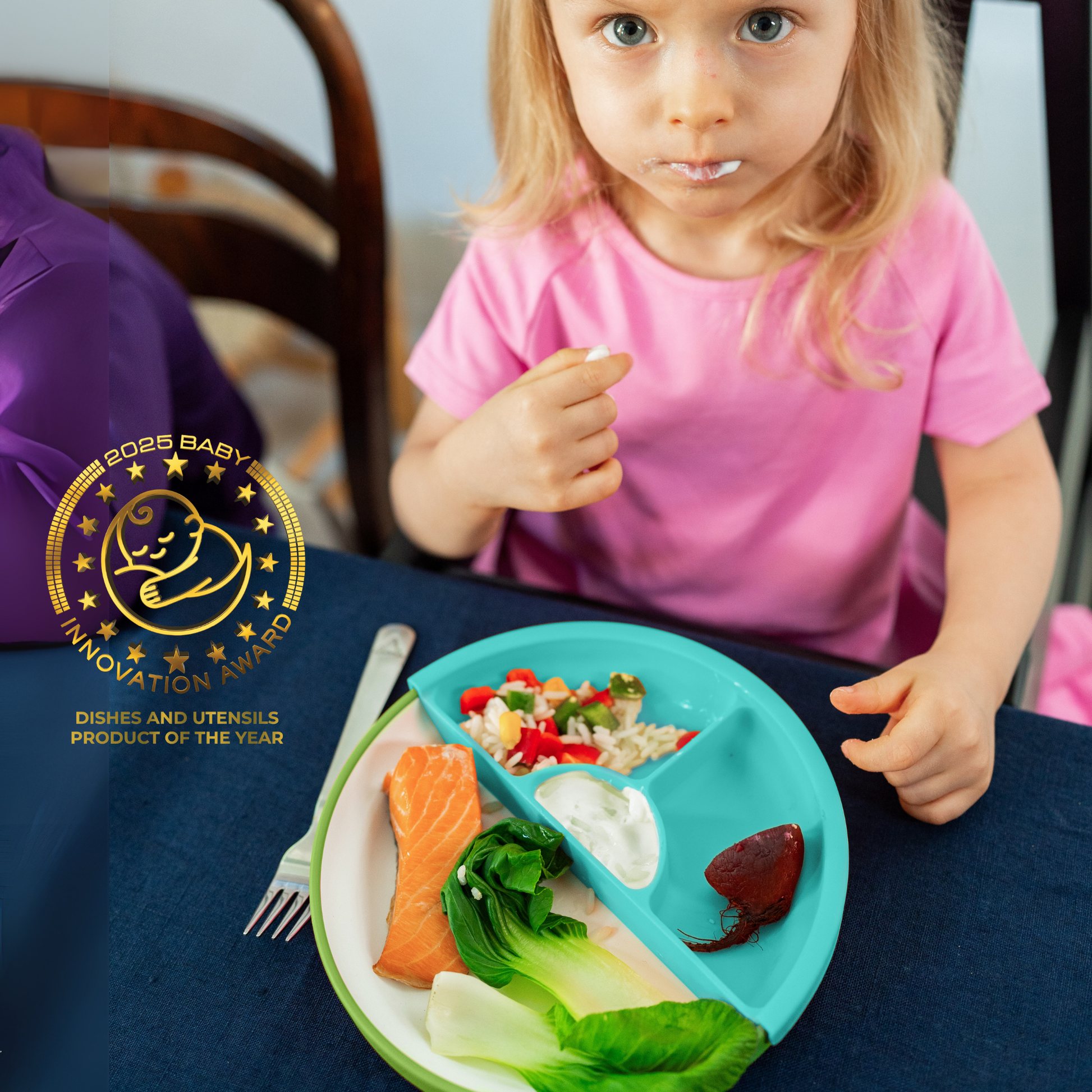 Child eating from a divided plate with a 2025 Baby Innovation Award logo.