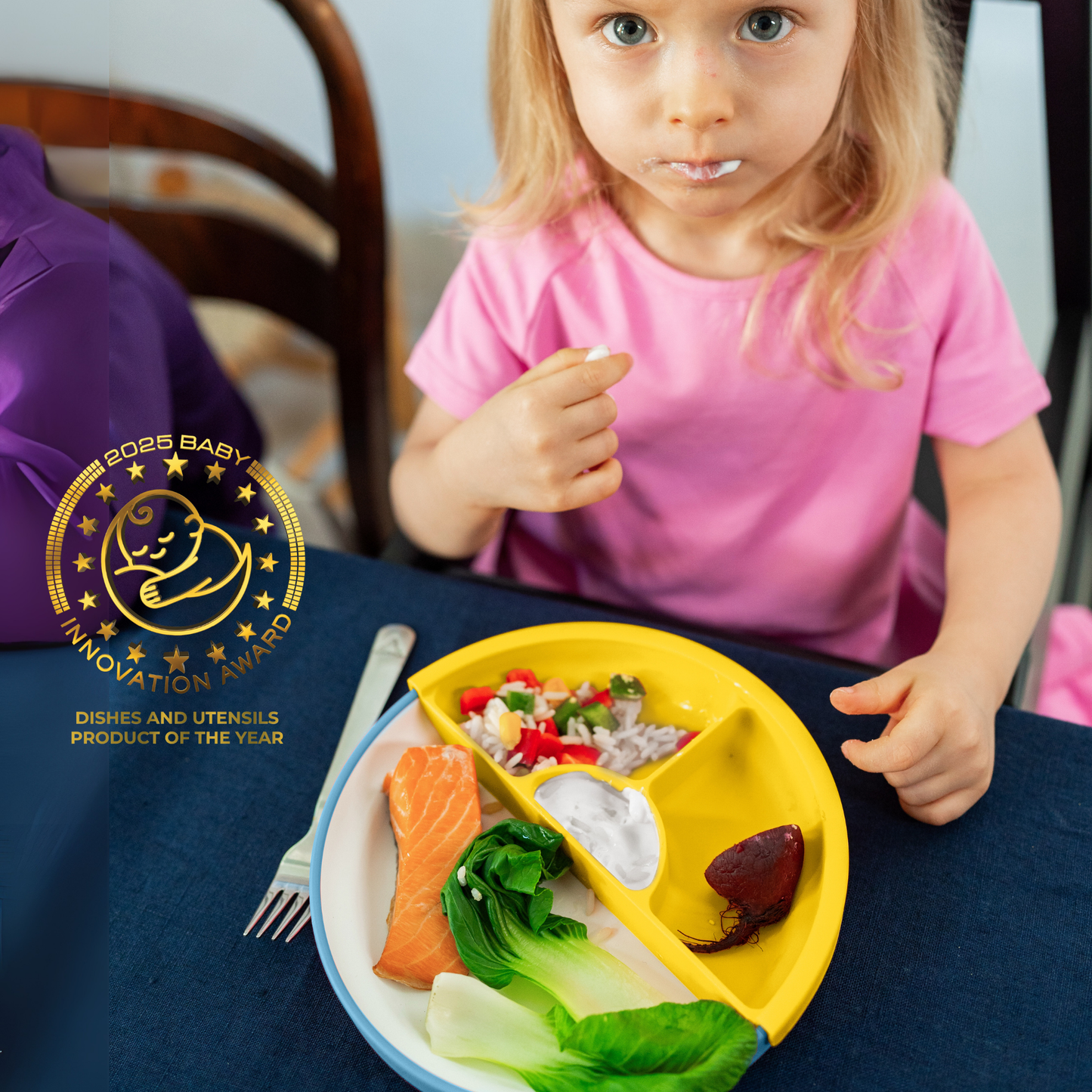 Child eating from a divided plate with a 2025 Baby Innovation Award logo.