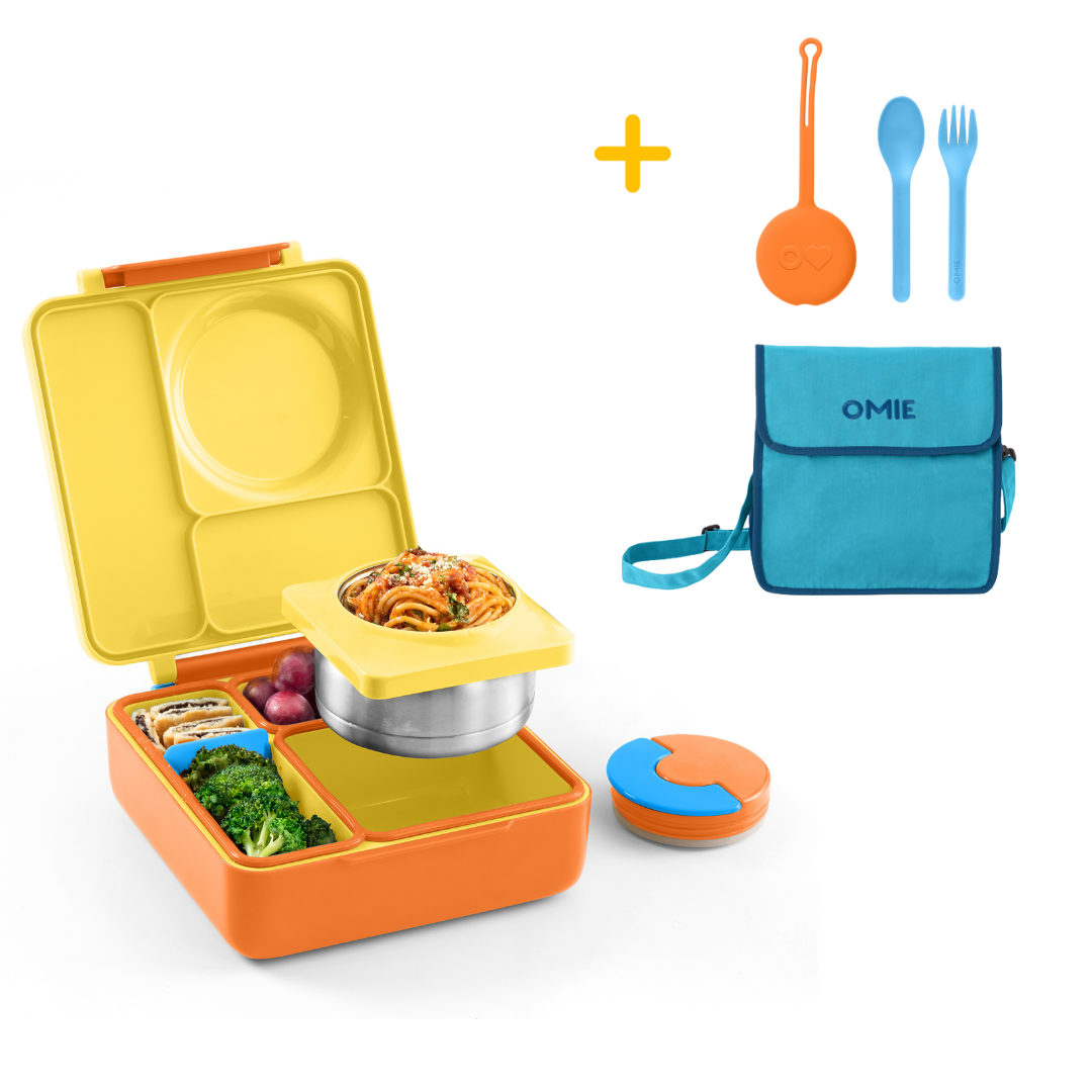 Colorful bento box with food compartments, a blue bag, and utensils on a white background.