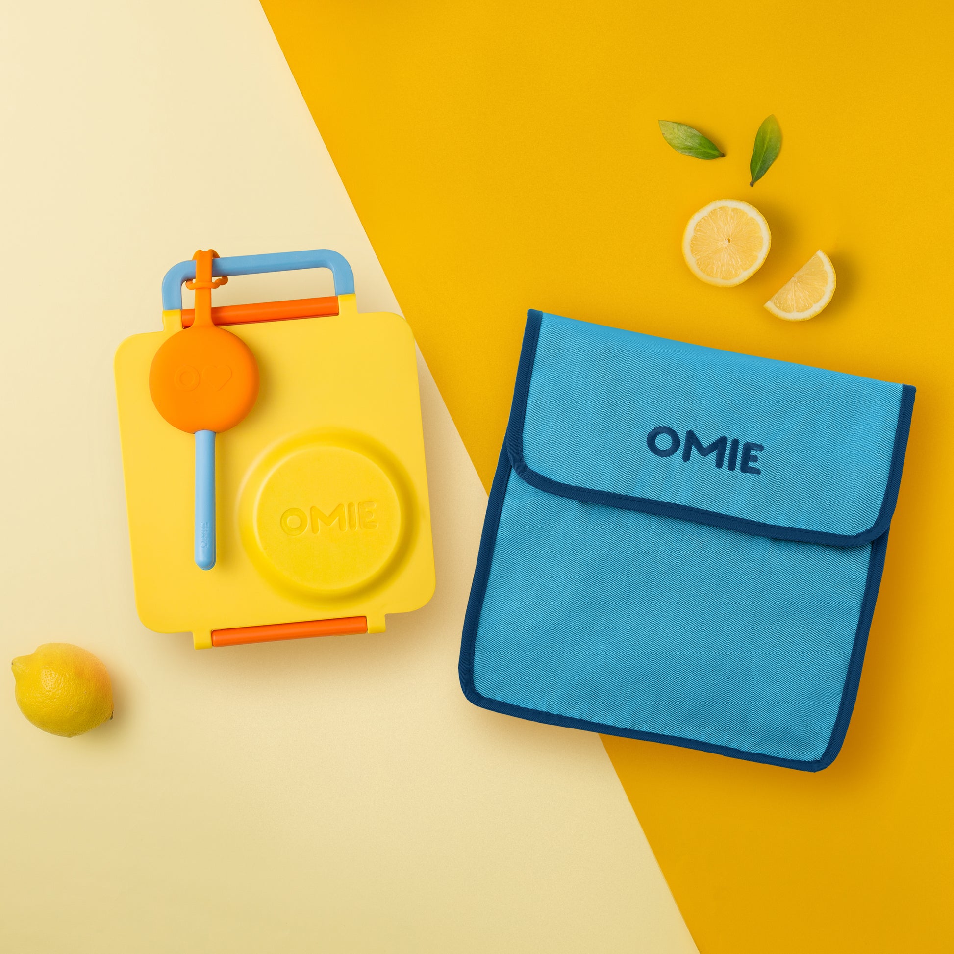 Yellow and blue OMIE products on a yellow background with lemons.